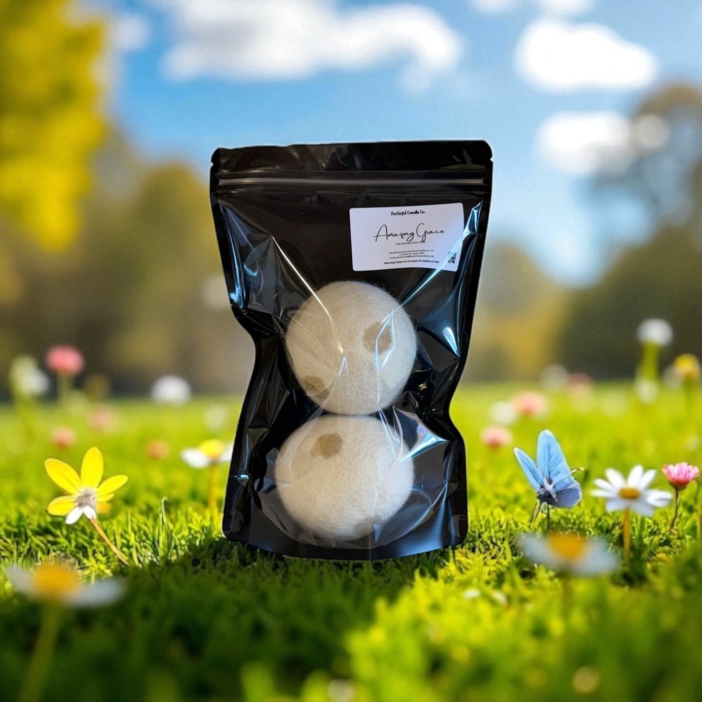 Two bath bombs in a clear plastic bag with a black zipper on a grassy background.