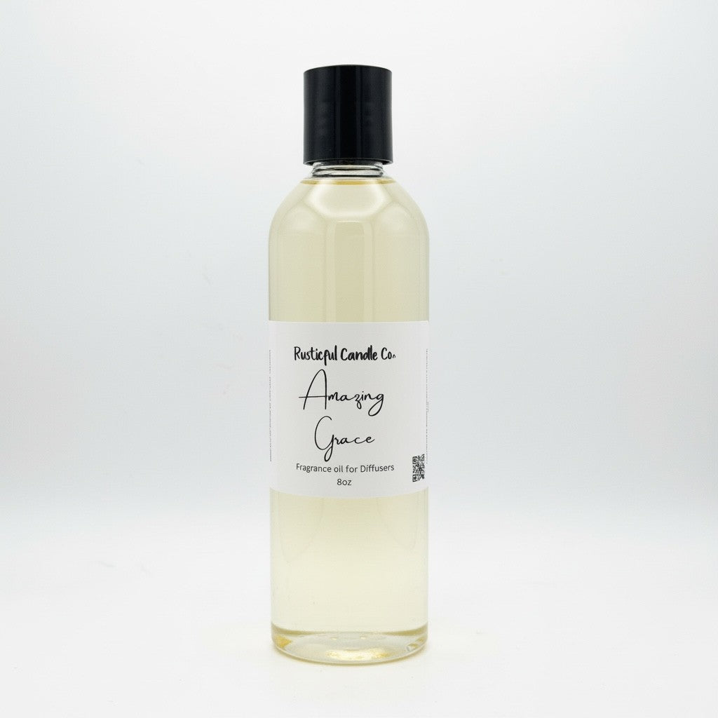 A clear glass bottle of fragrance oil with a black cap and a white label reading 'Relentless Candle Co. Amazing Grace' on a clean white background.
