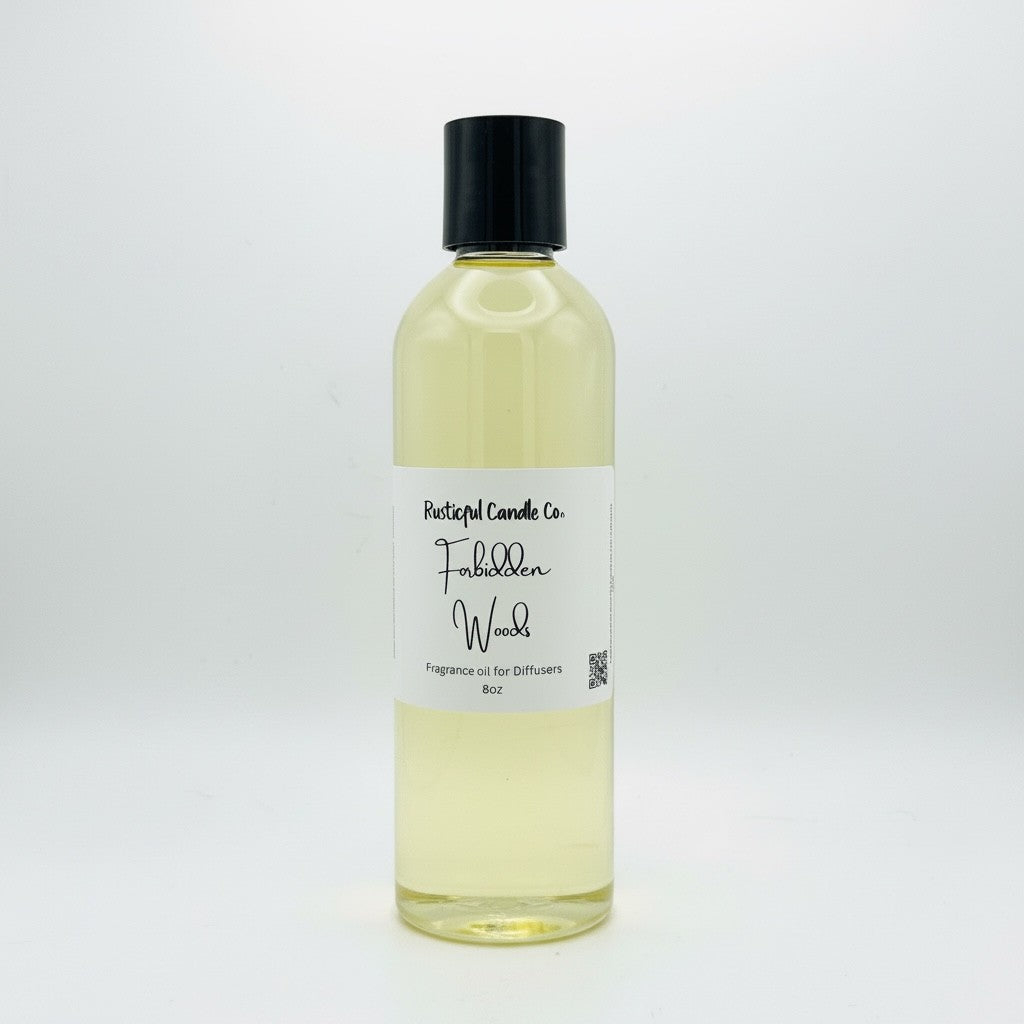 A 8oz bottle of Portugal Candle Co. Fabbed Wood fragrance oil, featuring a clear plastic bottle filled with pale yellow liquid, a white paper label with black text, and a black screw cap, set against a plain white background.