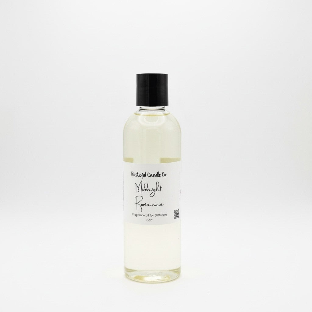 A clear glass bottle of 'Midnight Romance' diffuser oil by Rustical Candles Co, featuring a black cap and a white label, set against a seamless white background.