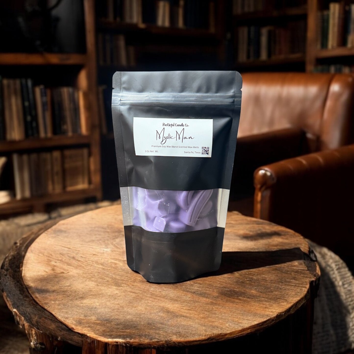 Black coffee packaging with a label on a wooden surface in a cozy room.