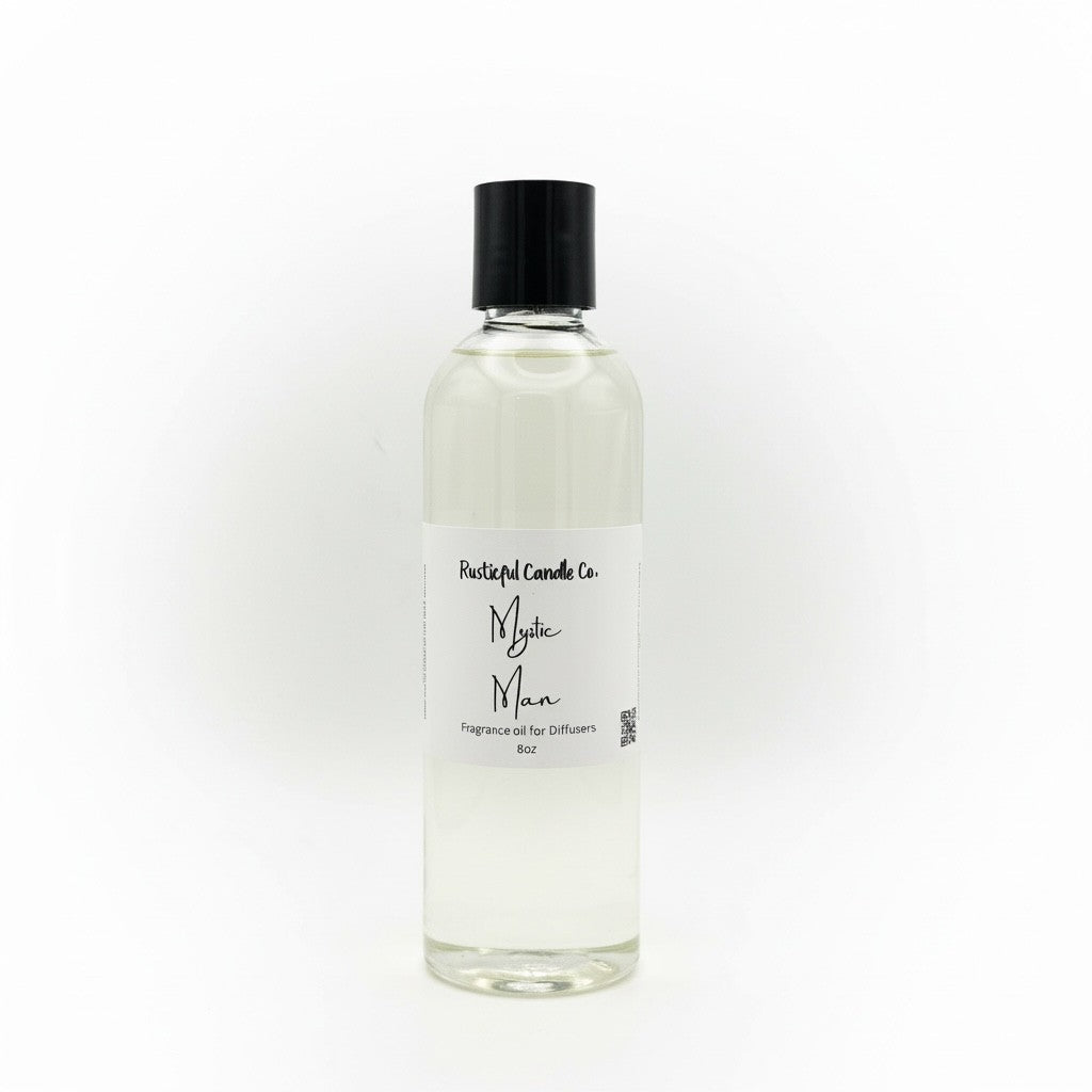 A clear glass bottle of Mystic Man fragrance oil with a black cap and a white label, shown on a plain white background.