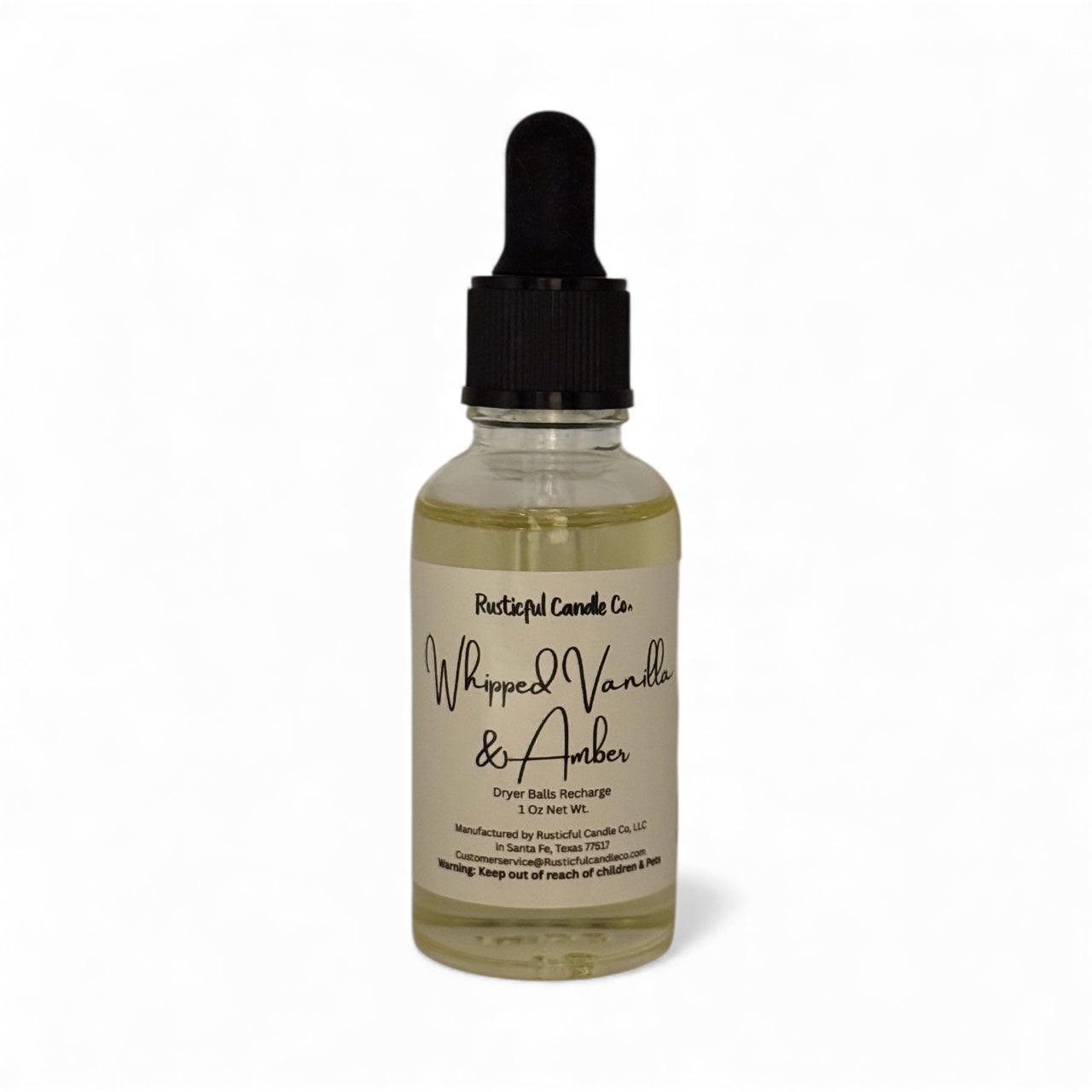 Bottle of 'Whipped Vanilla & Amber' candle refill with dropper on a white background