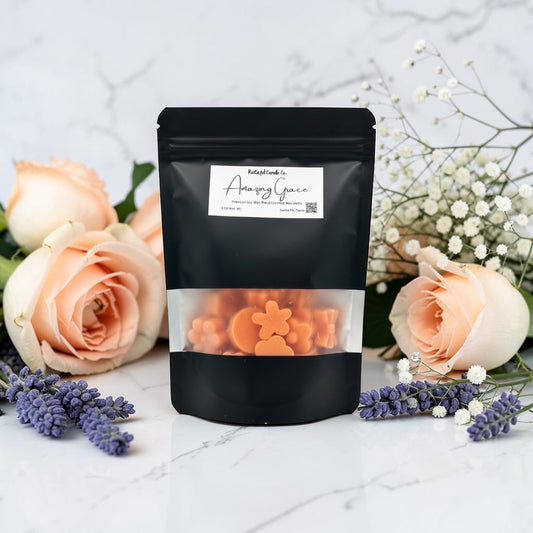 Black packaging with orange contents on a marble surface with flowers