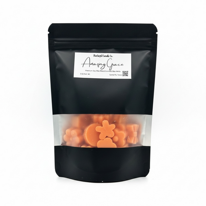Black pouch with clear window displaying orange flower-shaped candies and 'Amory Grace' label.