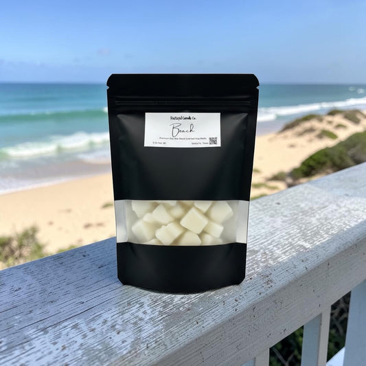Black packaging with white contents on a wooden ledge with a beach background