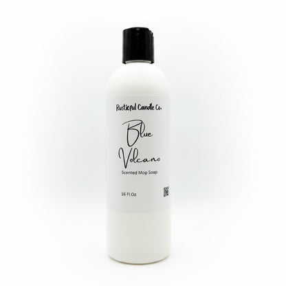 A 16 fl oz white bottle of Rustical Candle Co. Blue Volcano Scented Mop Soap with a black cap, shown on a clean white background.