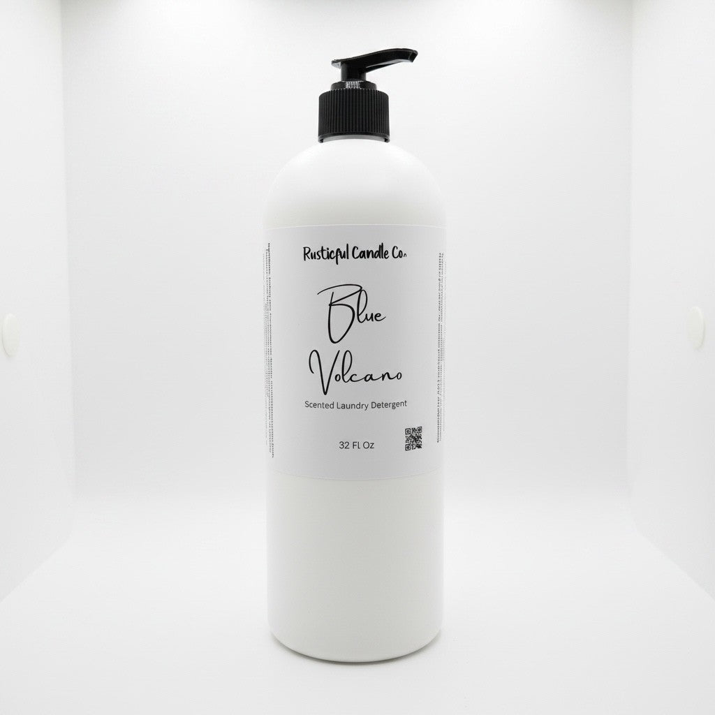 A 32 fl oz white plastic bottle of Rustical Candle Co. Blue Volcano Scented Laundry Detergent with a black pump dispenser and a white label, set against a seamless white background.