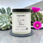 Candle labeled 'Cactus Flower' by Rusticful Candle Co. with succulents and a cactus in the background.