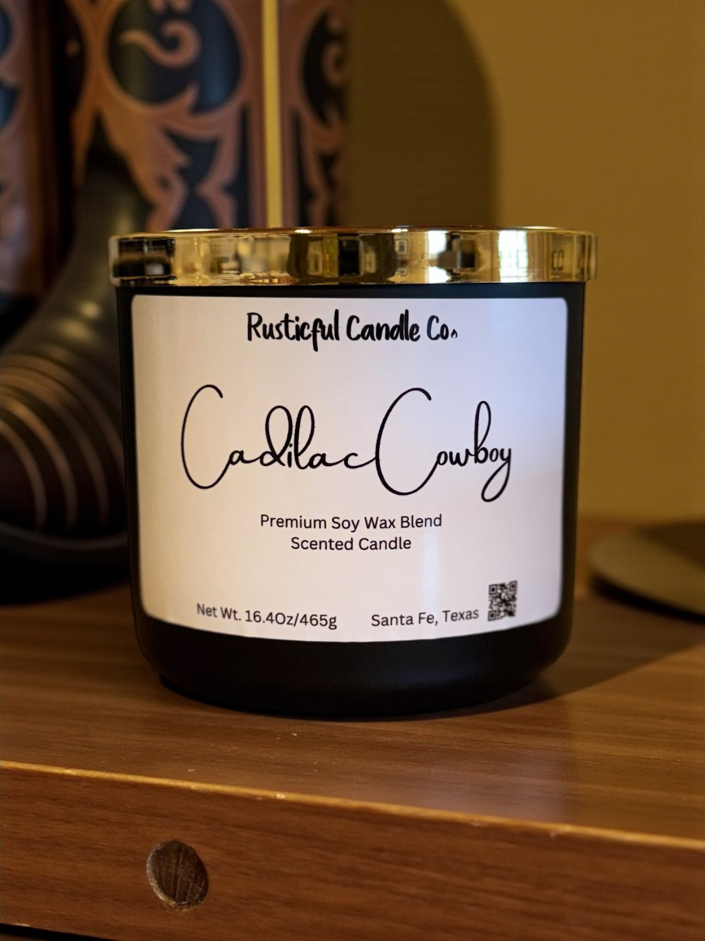 Candle with 'Rusticful Candle Co.' label on a wooden surface