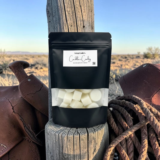 Black package with white contents on a wooden post in a desert setting