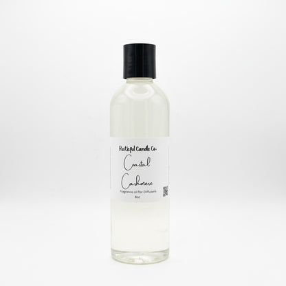 A clear glass bottle of Fragrant Candle Co. Coastal Cadaver fragrance oil with a black cap and white label, set against a seamless white background.