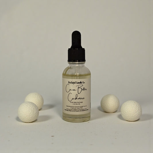 Bottle of Cacao Butter Cashmere with white balls on a gray background