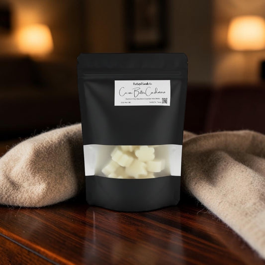 Black packaging of cream butter cashews on a wooden surface with a blurred background