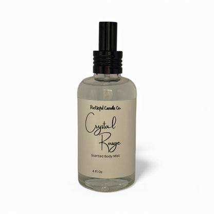 Clear glass bottle with black spray nozzle labeled 'Crystal Rouge' on a white background