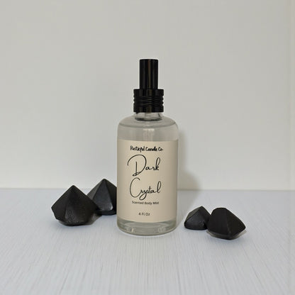 Body mist bottle labeled 'Dark Crystal' with black geometric shapes on a light gray background