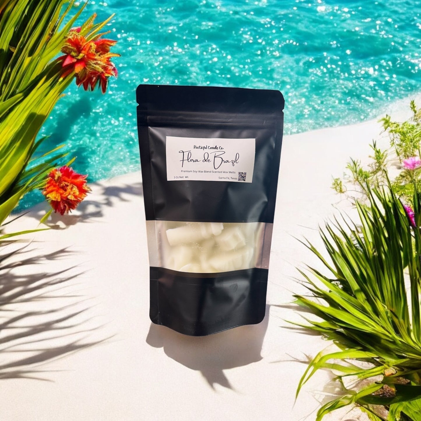Black package with a label on a white surface with flowers and water in the background