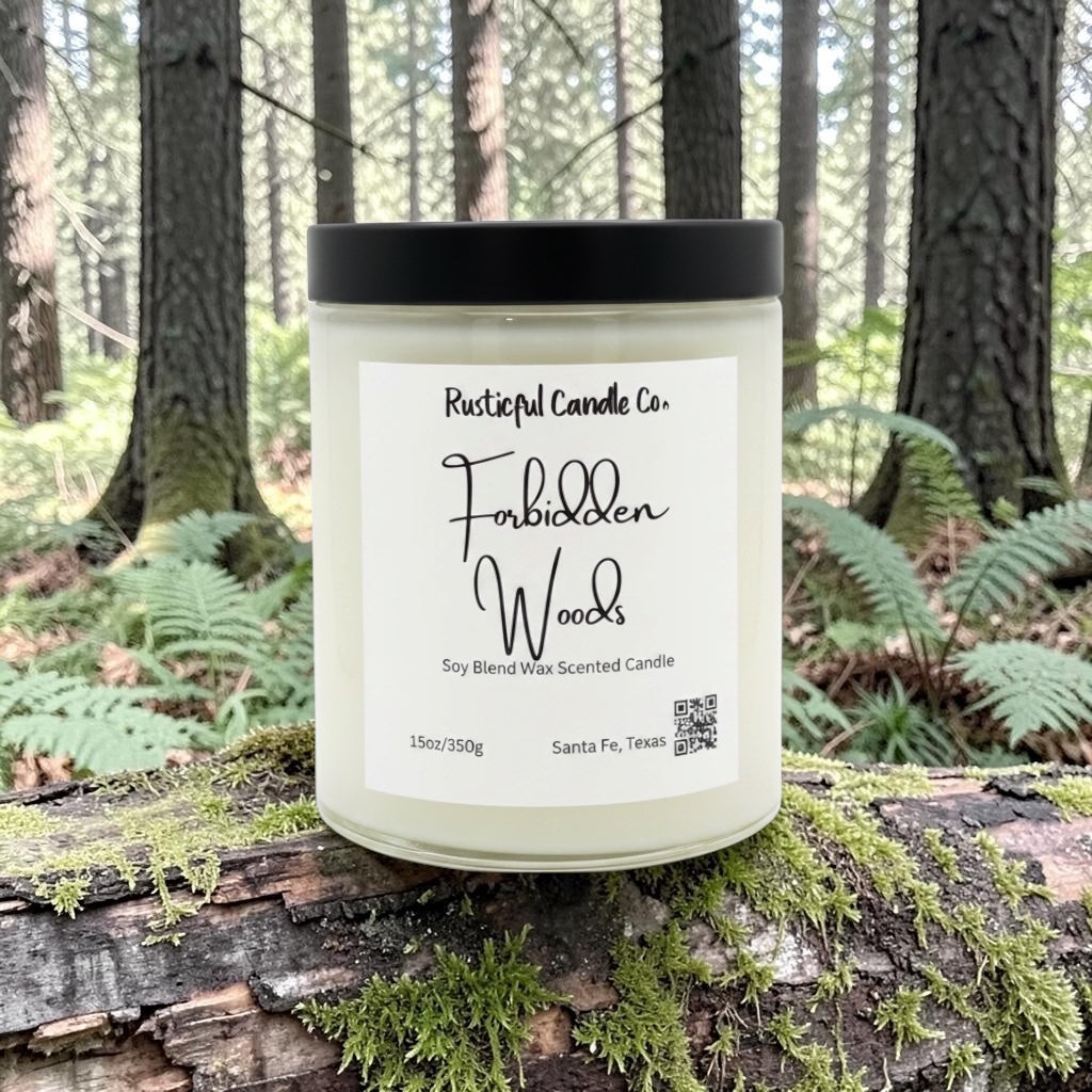 Candle labeled 'Forbidden Woods' by Rusticful Candle Co. on a log in a forest setting.