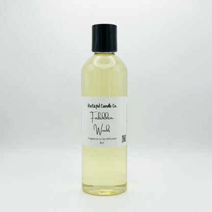 A 8oz bottle of Portugal Candle Co. Fabbed Wood fragrance oil, featuring a clear plastic bottle filled with pale yellow liquid, a white paper label with black text, and a black screw cap, set against a plain white background.