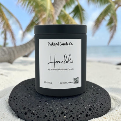 Honolulu candle on a volcanic rock with palm trees and ocean backdrop