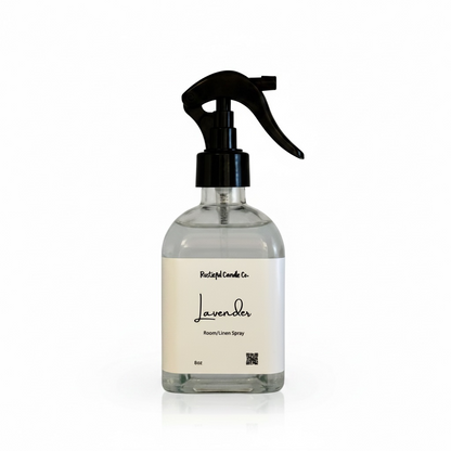 Clear spray bottle with black nozzle labeled 'Pacifica Candle Co. Lavender Room/Linen Spray' on a white background