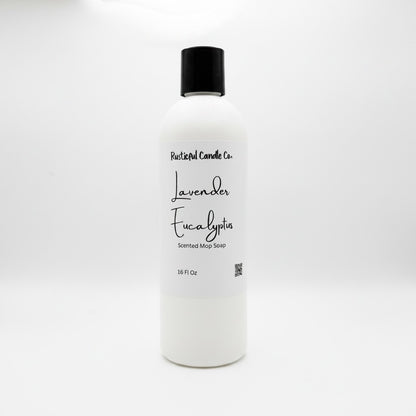 A 16 fl oz white plastic bottle of Rustical Candle Co. Lavender Eucalyptus Scented Mop Soap with a black cap, set against a plain white background.
