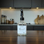 Clear spray bottle labeled 'Maverick' on a kitchen counter