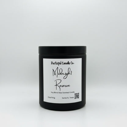 A black jar candle with a white label reading 'Rustical Candle Co. Midnight Reserve' on a light gray studio background.