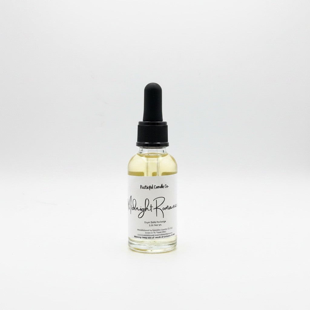 A small clear glass dropper bottle with pale yellow liquid inside, a black dropper cap, and a white label reading 'Paisley Lane Co' and 'Night Romance'.