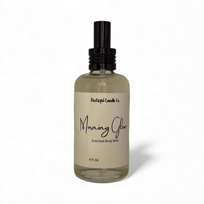 Clear bottle of 'Morning Glow' scented body mist with a black spray nozzle on a white background.