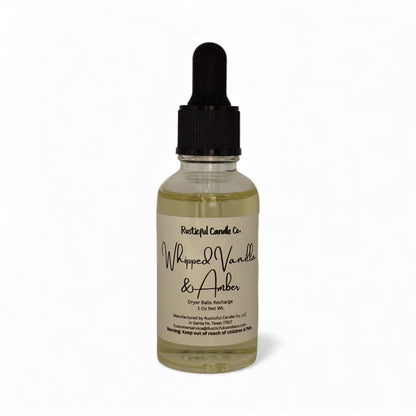 Bottle of 'Whipped Vanilla & Amber' candle refill with dropper on a white background