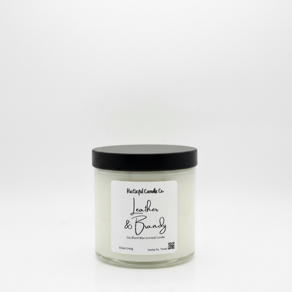 Candle jar labeled 'Leather & Brandy' on a white background