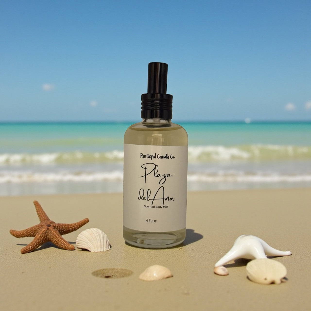 Bottle of 'Playa Del Amor' body mist on a sandy beach with ocean view