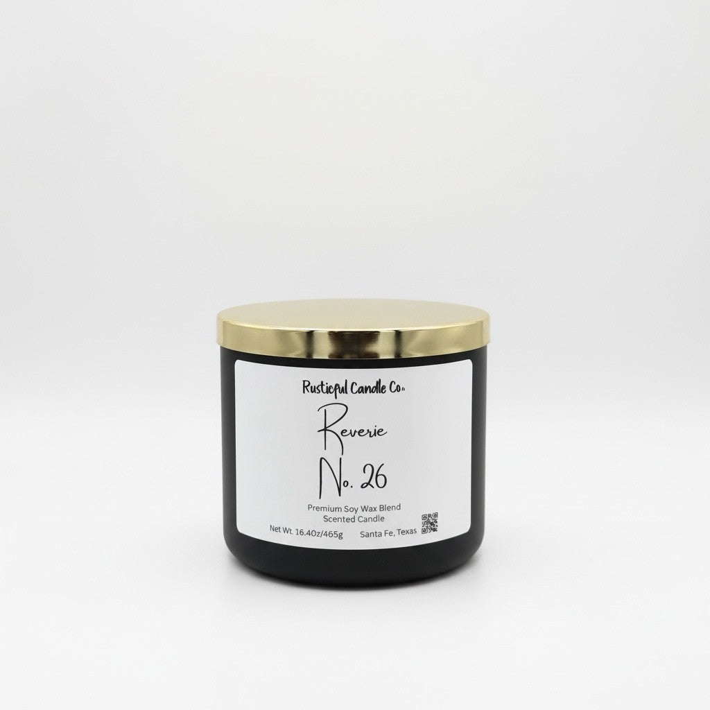 A black jar candle with a shiny gold lid and a white label reading 'Postfulful Candle Co. Reverse No.