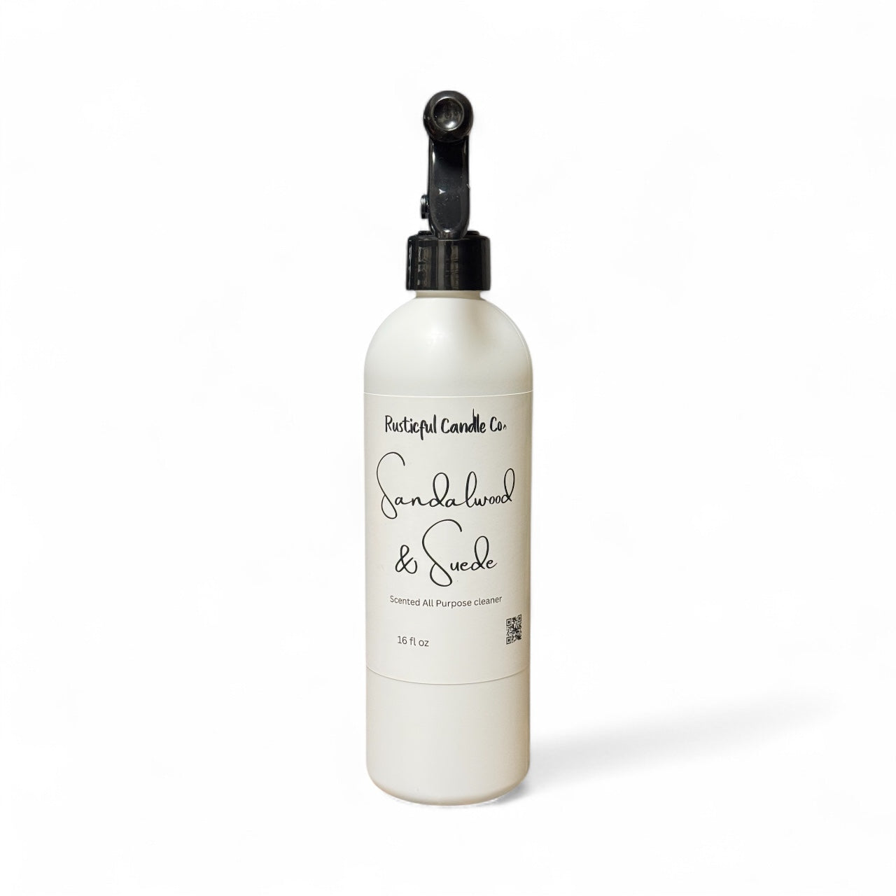 White bottle with black cap labeled 'Sandalwood & Suede' on a white background