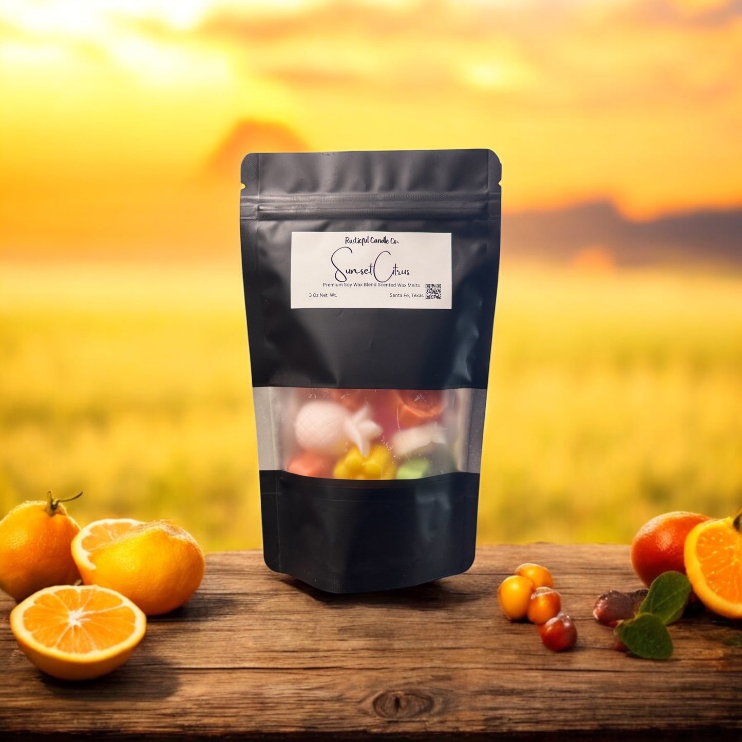 Black snack bag with transparent window displaying colorful contents, placed on a wooden surface with oranges and other fruits against a yellow blurred background.