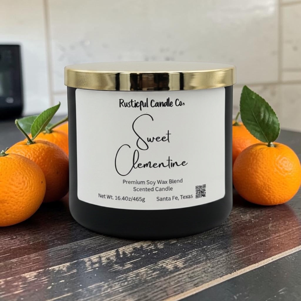 Candle labeled 'Sweet Clementine' from Rusticful Candle Co. with oranges on a wooden surface.