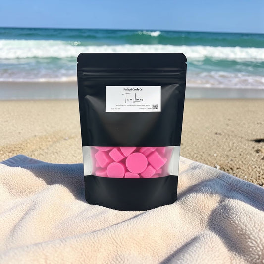 Black package with pink contents on a beach