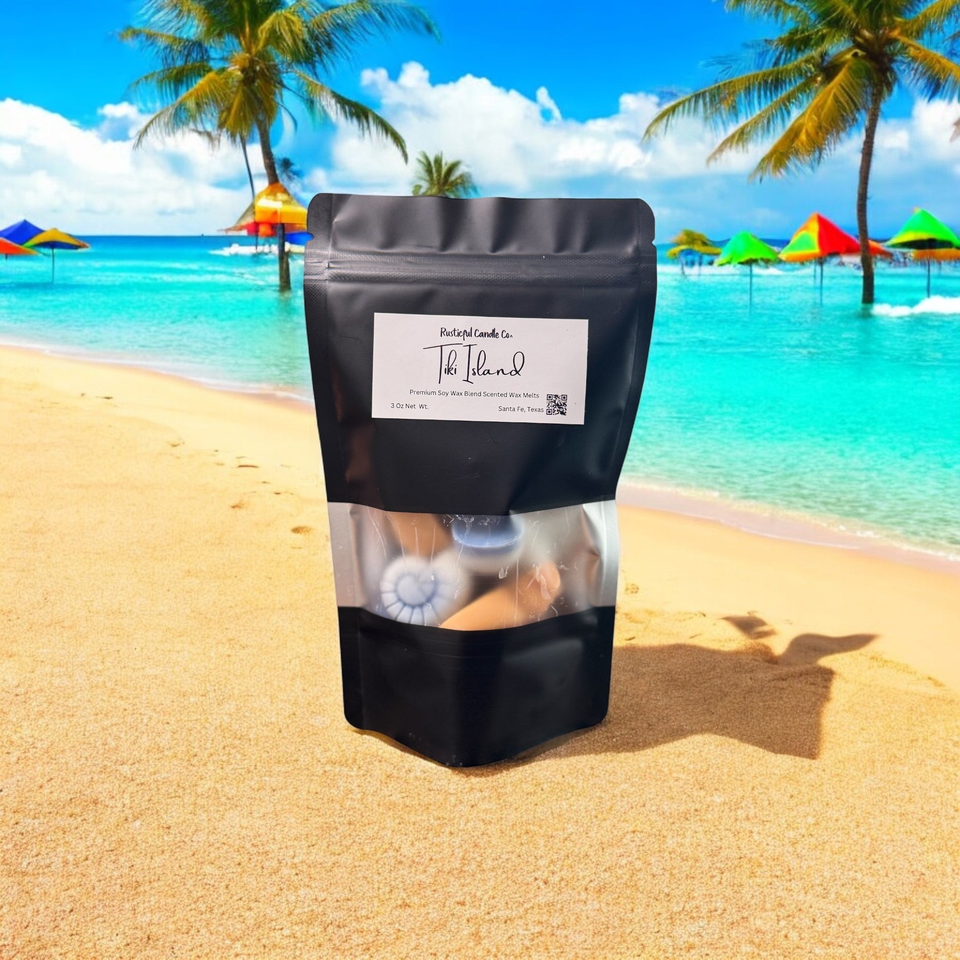 Black package with a label on a sandy beach with palm trees and colorful umbrellas in the background.