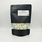 Black packaging of tropical fruit-infused product with visible contents on a white background