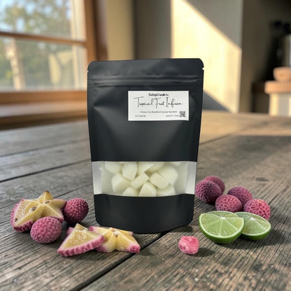 Black packaging of white candy on a wooden surface with fruit slices and candy pieces.