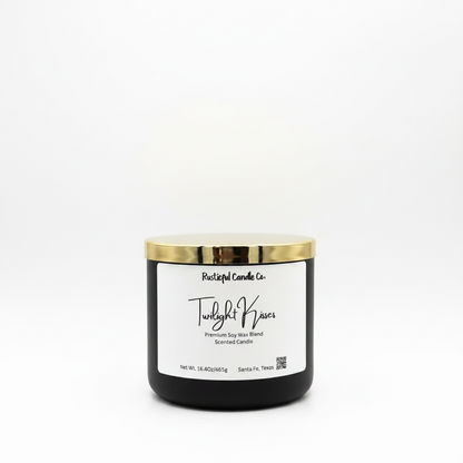 Black candle with gold lid and white label on a white background