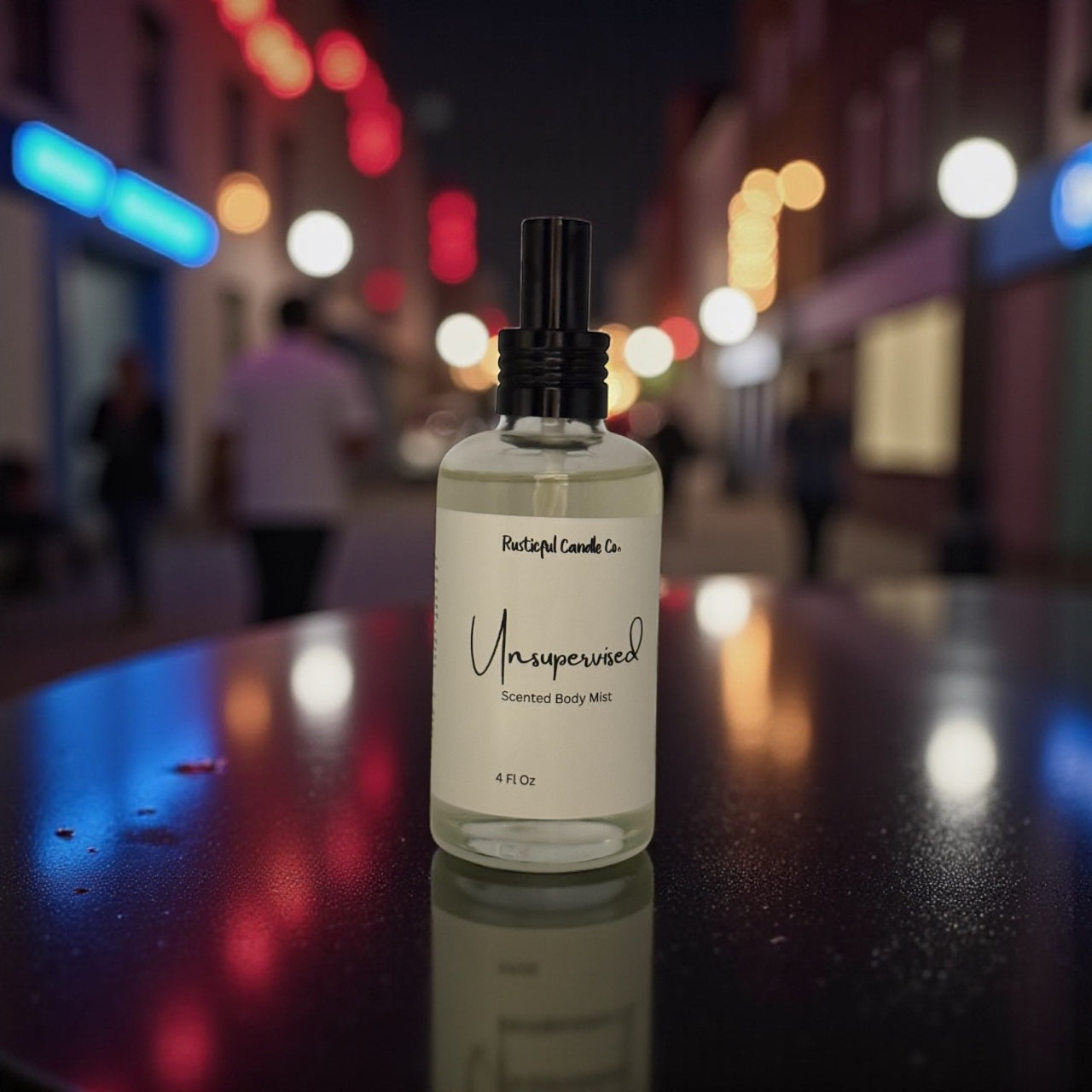 Bottle of 'Unsupervised' scented body mist on a reflective surface with a blurred city street background