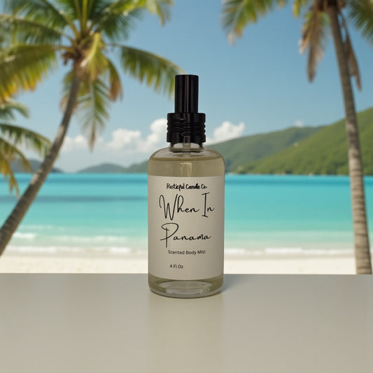 Bottle of 'When In Panama' scented body mist with a tropical beach background