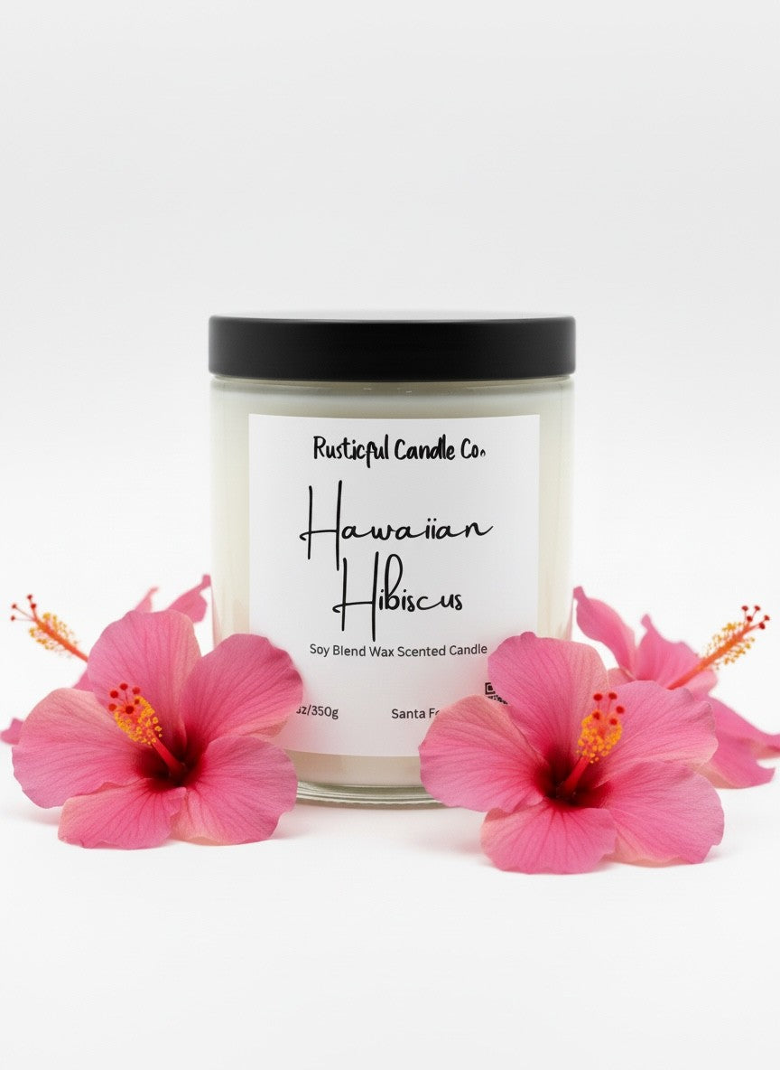 Candle with 'Hawaiian Hibiscus' label surrounded by pink flowers on a white background