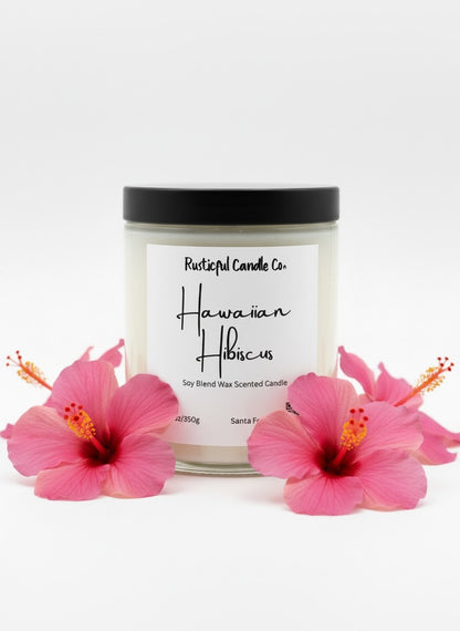 Candle with 'Hawaiian Hibiscus' label surrounded by pink flowers on a white background