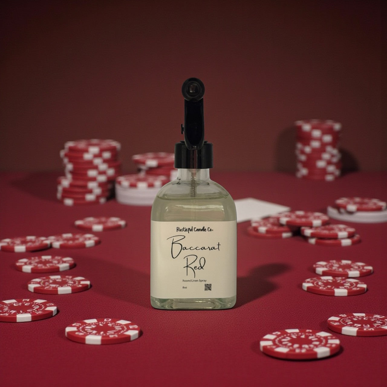 Bottle of Baccarat Red candle on a red background with poker chips.
