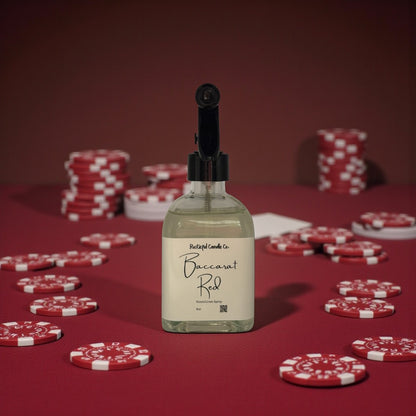 Bottle of Baccarat Red candle on a red background with poker chips.